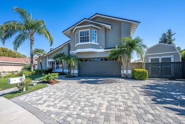 front of property with a garage and a storage shed