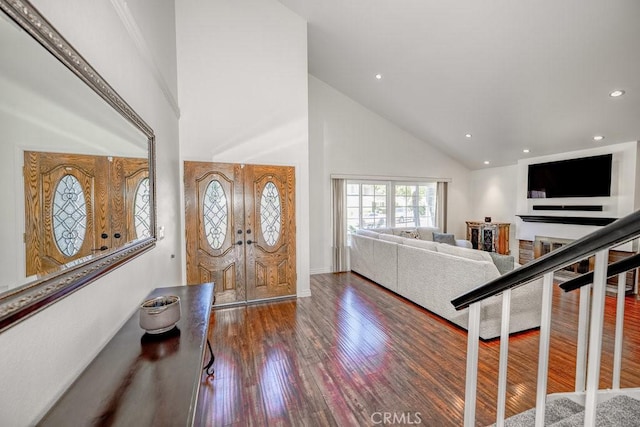 foyer with french doors, dark hardwood / wood-style flooring, and high vaulted ceiling