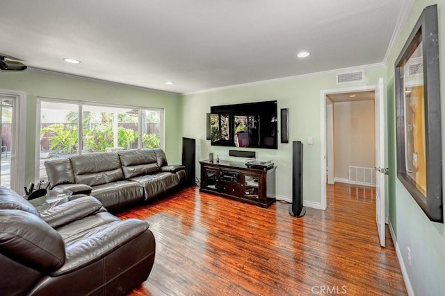 living room featuring hardwood / wood-style flooring and ornamental molding