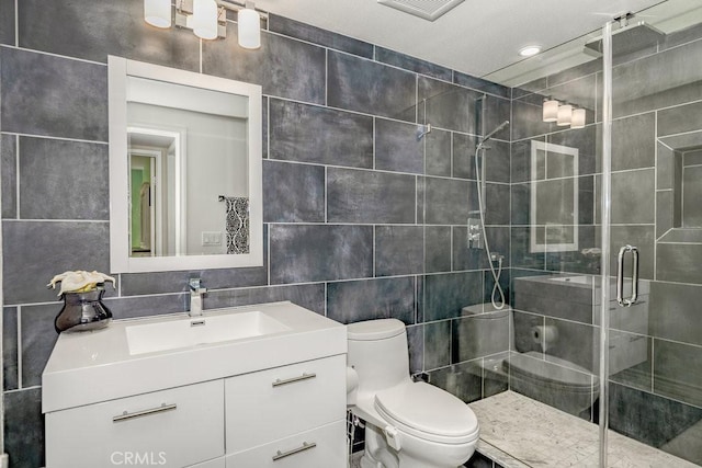 bathroom with walk in shower, toilet, decorative backsplash, vanity, and tile walls