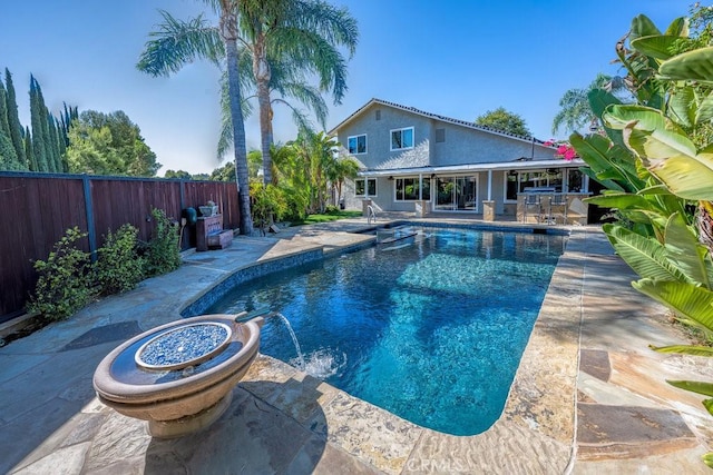 view of pool featuring pool water feature and a patio