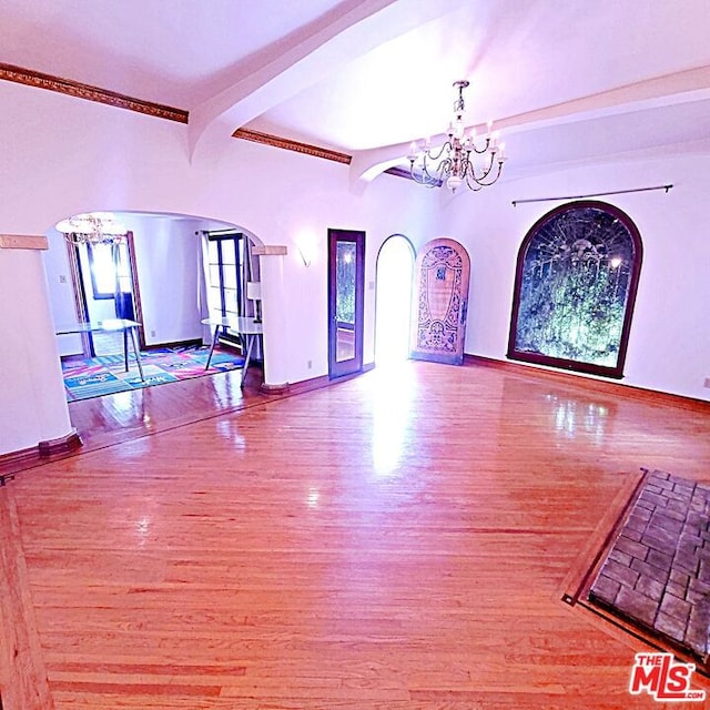 interior space featuring beamed ceiling, a chandelier, and hardwood / wood-style floors