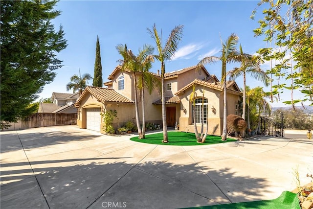 mediterranean / spanish-style home with a garage