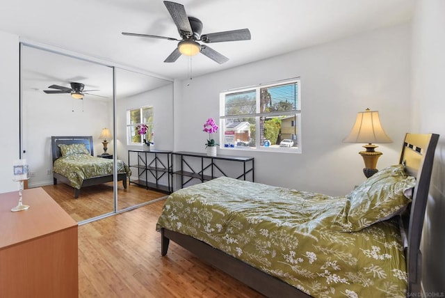 bedroom featuring wood-type flooring, a closet, and ceiling fan