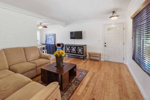 living room with light wood-type flooring, ceiling fan, and crown molding