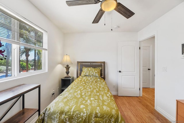 bedroom featuring ceiling fan and hardwood / wood-style flooring