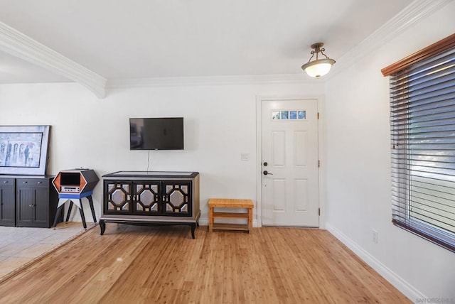 foyer entrance featuring light hardwood / wood-style floors and crown molding