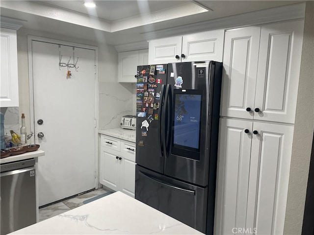 kitchen featuring stainless steel appliances, hanging light fixtures, and white cabinetry