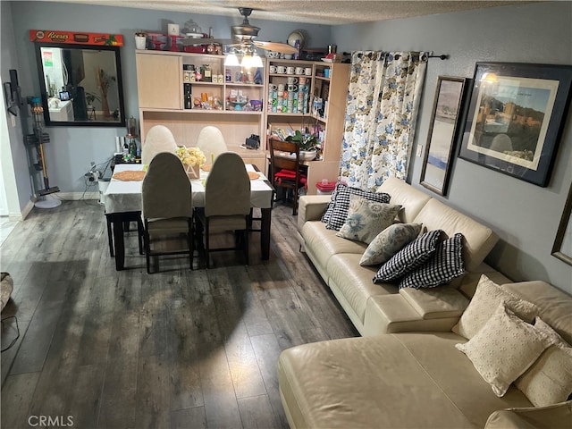 interior space featuring ceiling fan, a textured ceiling, and dark wood-type flooring