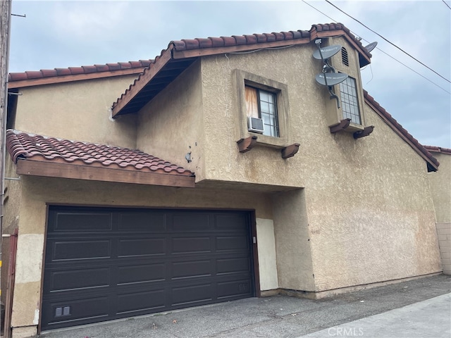 exterior space featuring cooling unit and a garage