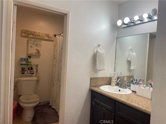 bathroom featuring tile patterned flooring, vanity, and toilet