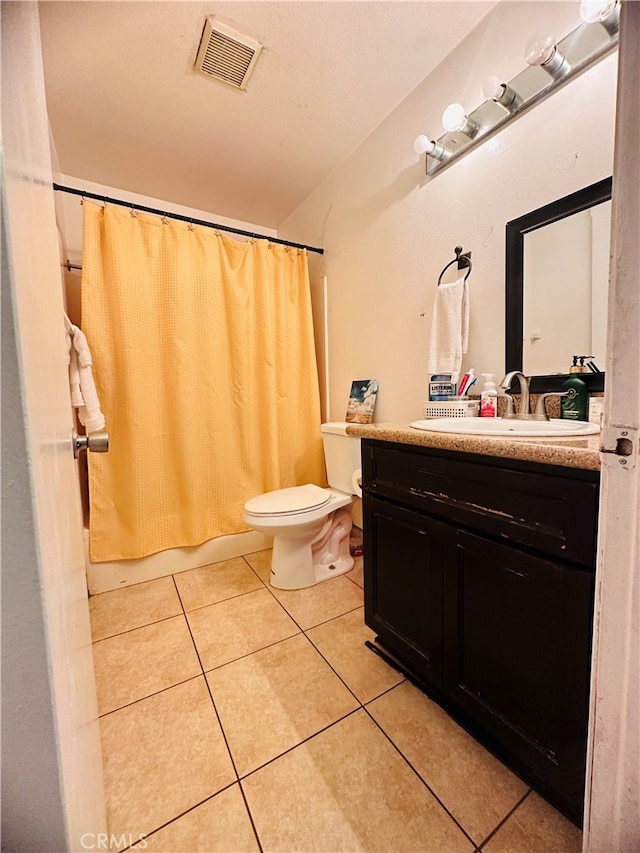 full bathroom with shower / bath combo, tile patterned flooring, vanity, and toilet