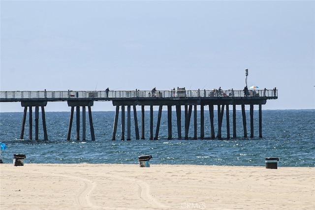 dock area with a water view and a view of the beach