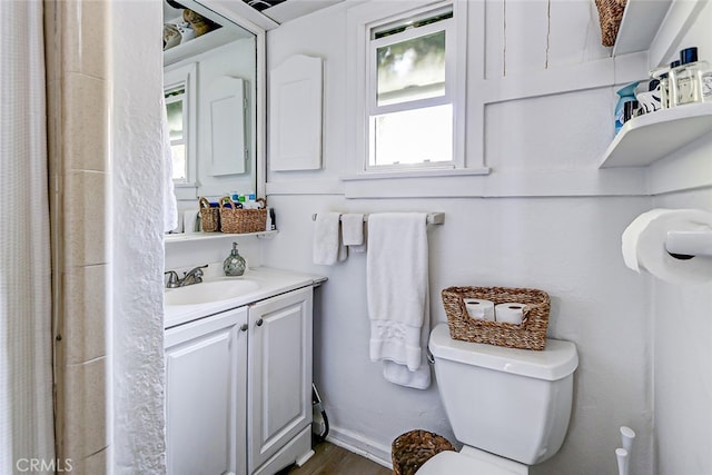 bathroom featuring vanity, hardwood / wood-style floors, and toilet