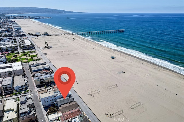 drone / aerial view with a water view and a beach view