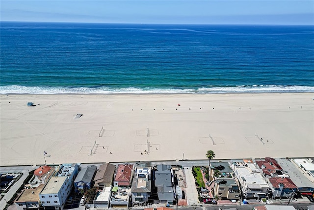 bird's eye view featuring a view of the beach and a water view