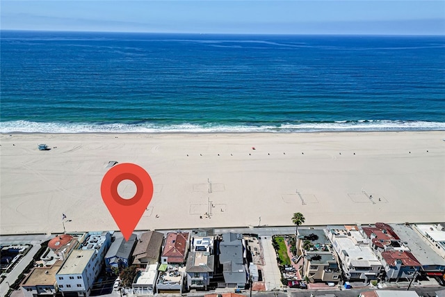 bird's eye view with a water view and a view of the beach