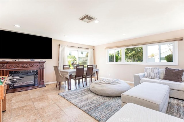 living room featuring a wealth of natural light and light tile patterned flooring