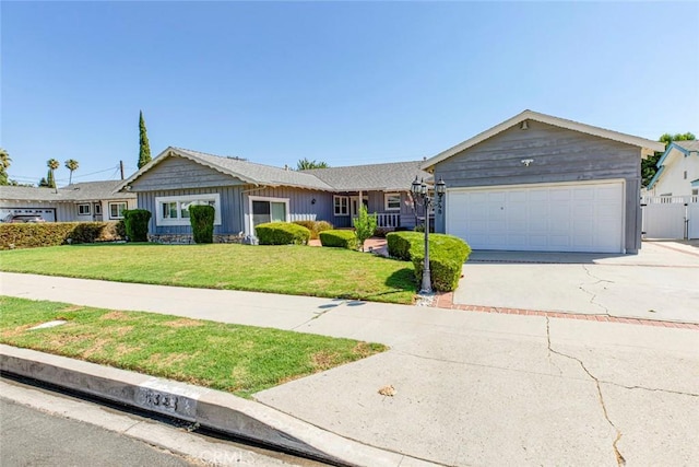 single story home featuring a garage and a front lawn