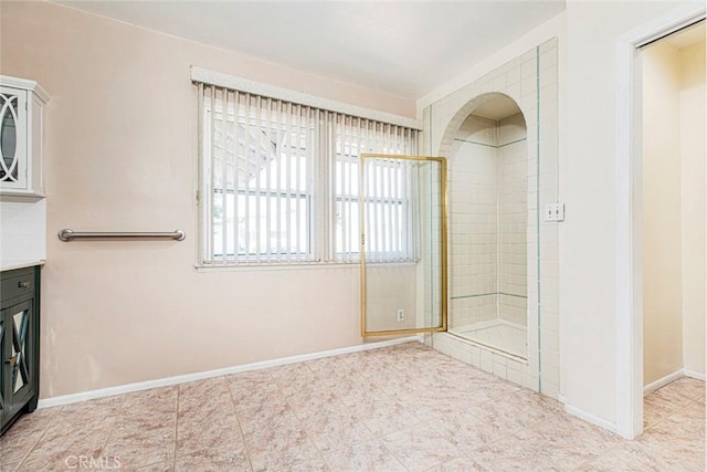 bathroom with vanity and tiled shower