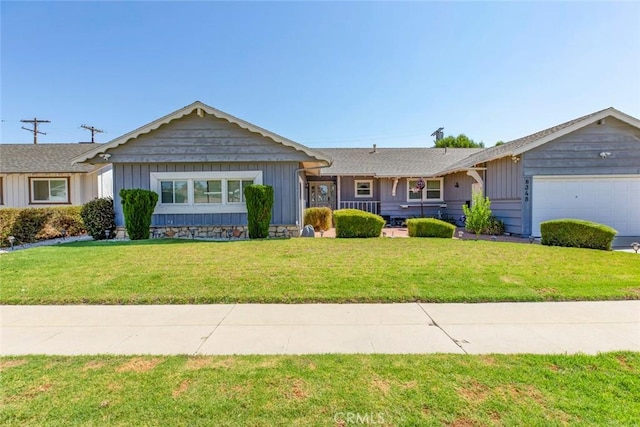 ranch-style house featuring a garage and a front yard