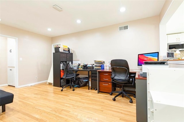 office space with light hardwood / wood-style flooring