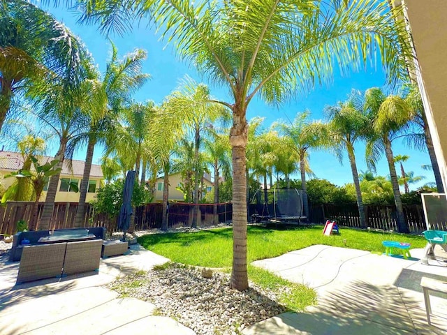 view of yard with a trampoline, outdoor lounge area, and a patio