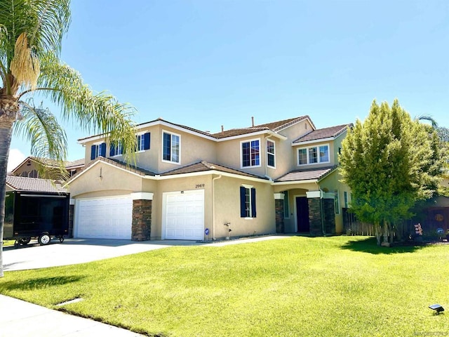 view of front of home with a front yard and a garage