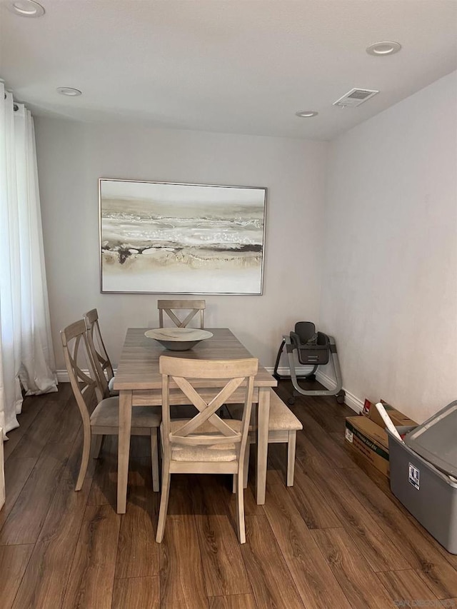 dining space with dark hardwood / wood-style floors