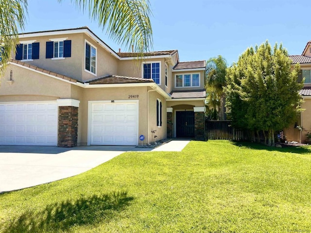 view of front of house featuring a front lawn and a garage