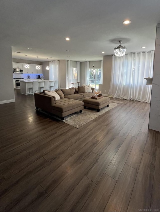 unfurnished living room featuring dark hardwood / wood-style flooring