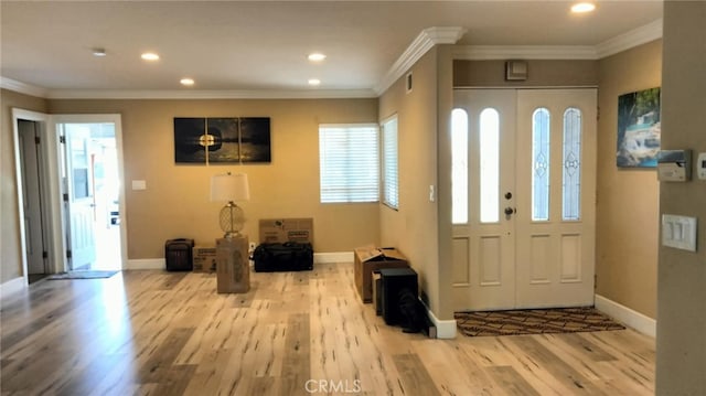 entryway featuring ornamental molding and light wood-type flooring