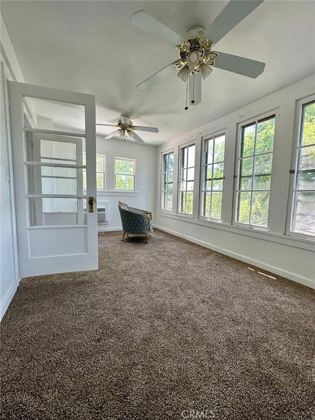 interior space with carpet and ceiling fan