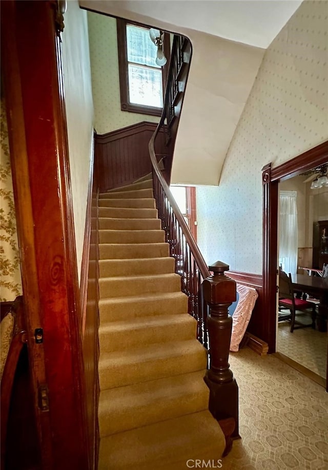 staircase featuring vaulted ceiling