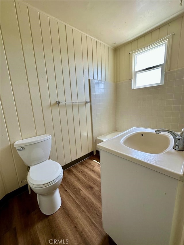 bathroom with vanity, toilet, and hardwood / wood-style flooring