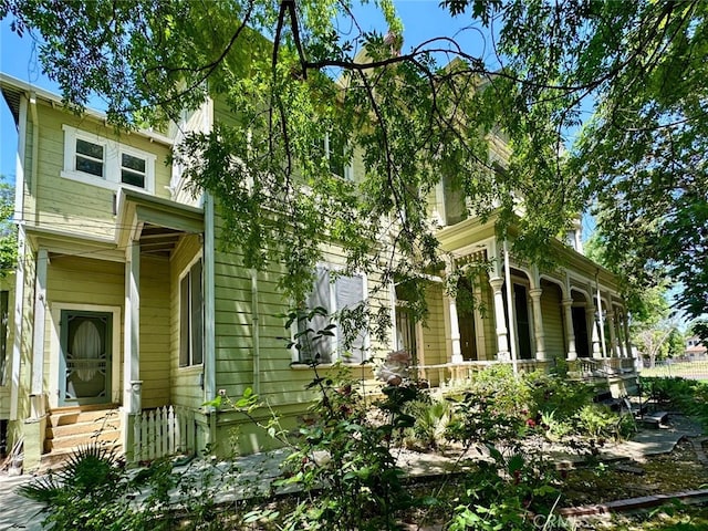 view of side of property with covered porch