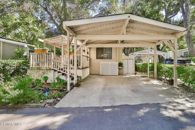 view of front of home with a carport and a shed