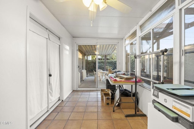 sunroom / solarium featuring ceiling fan