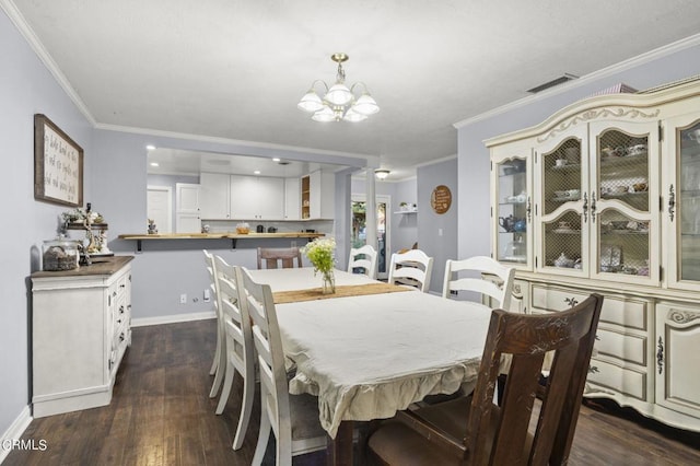 dining room featuring a chandelier, dark hardwood / wood-style flooring, and crown molding