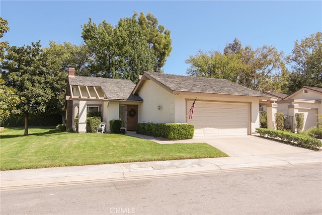 view of front of home featuring a garage and a front yard