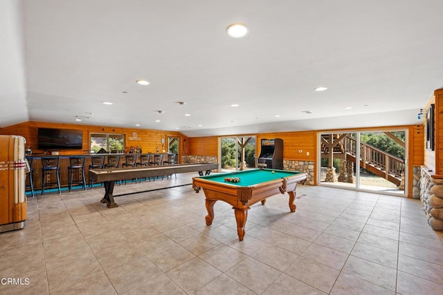 playroom with light tile patterned floors, lofted ceiling, pool table, and wooden walls