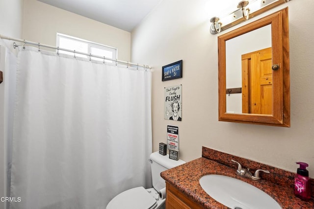 bathroom featuring toilet and vanity