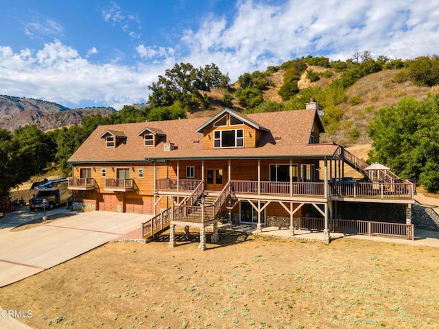 view of front of property featuring covered porch, a garage, and a mountain view