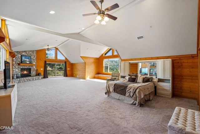 bedroom with light carpet, wooden walls, ceiling fan, lofted ceiling, and a fireplace