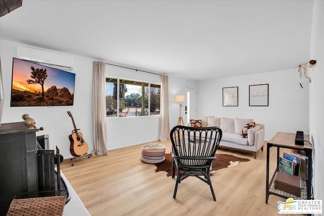 living room with an AC wall unit and light hardwood / wood-style flooring