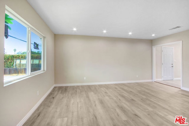 spare room featuring light hardwood / wood-style floors