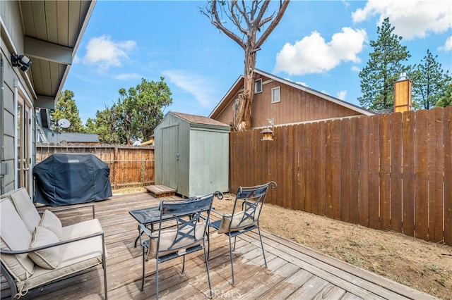 view of patio featuring area for grilling, a deck, and a storage unit