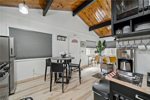 dining room featuring light wood-type flooring, vaulted ceiling with beams, and wooden ceiling