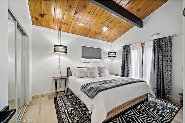 bedroom with wood ceiling, lofted ceiling with beams, light hardwood / wood-style flooring, and a closet