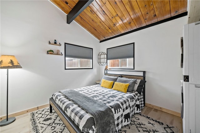 bedroom featuring light wood-type flooring, vaulted ceiling with beams, and wooden ceiling